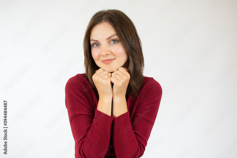 Portrait of a pretty young girl in red sweater hugging herself. Concept of selfish emotion. Portrait of a pretty young girl in red sweater hugging herself. Concept of selfish emotion.