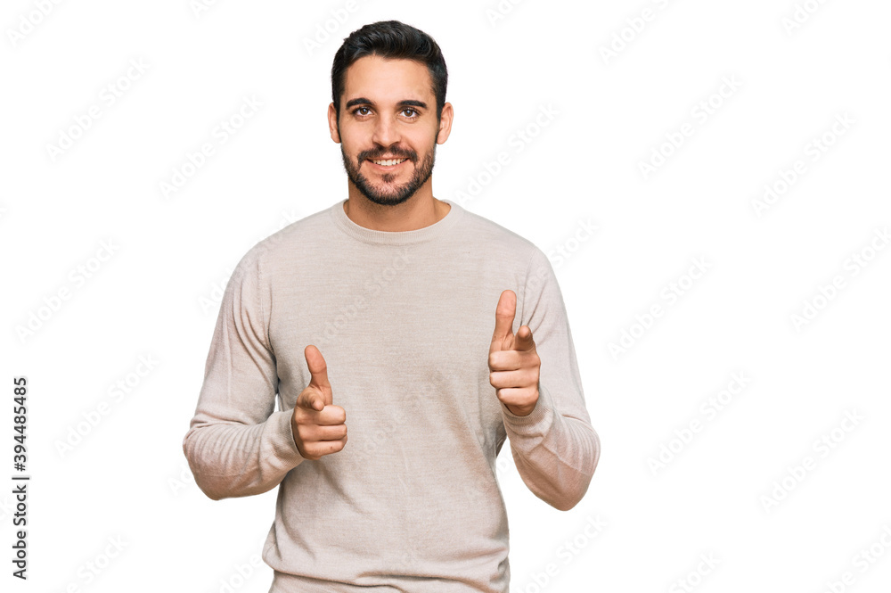 Young hispanic man wearing casual clothes pointing fingers to camera with happy and funny face. good energy and vibes. Young hispanic man wearing casual clothes pointing fingers to camera with happy and funny face. good energy and vibes.