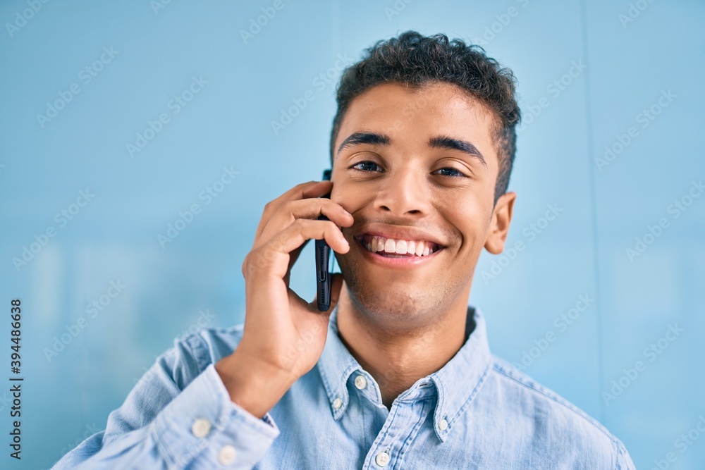 Young latin man smiling happy talking on the smartphone at the city. Young latin man smiling happy talking on the smartphone at the city.