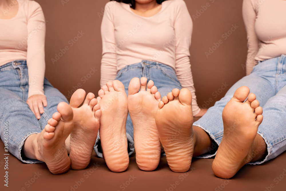 Bare feet and soles of contemporary young casual females of various  ethnicities Stock Photo