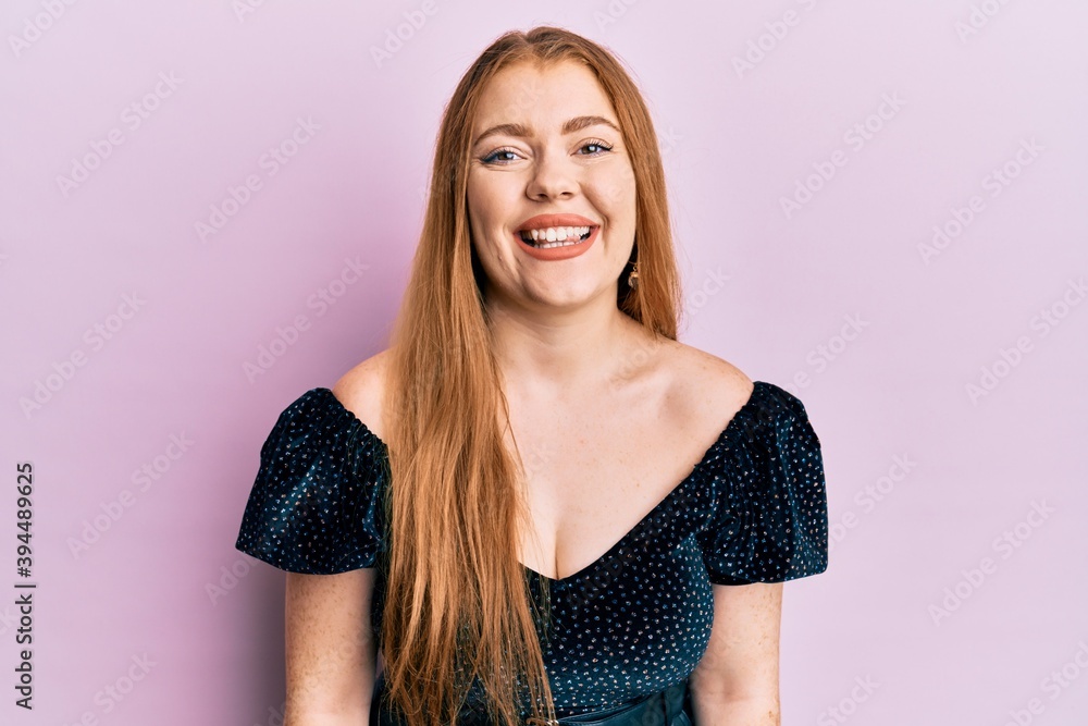 Young beautiful redhead woman wearing elegant and sexy look with a happy and cool smile on face. lucky person. Young beautiful redhead woman wearing elegant and sexy look with a happy and cool smile on face. lucky person.