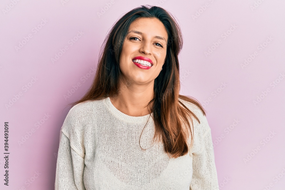 Fototapeta premium Beautiful hispanic woman wearing casual clothes smiling with an idea or question pointing finger up with happy face, number one