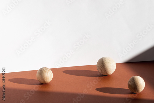 Modern product presentation background with wooden decor, shadows and light from window. Natural shadow overlay trendy effect on brown surface tabletop.