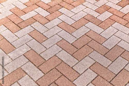 Vintage brown cobblestone pavement pattern and background