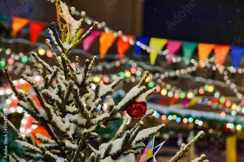 Christmas tree branches under the snow with decorative elements