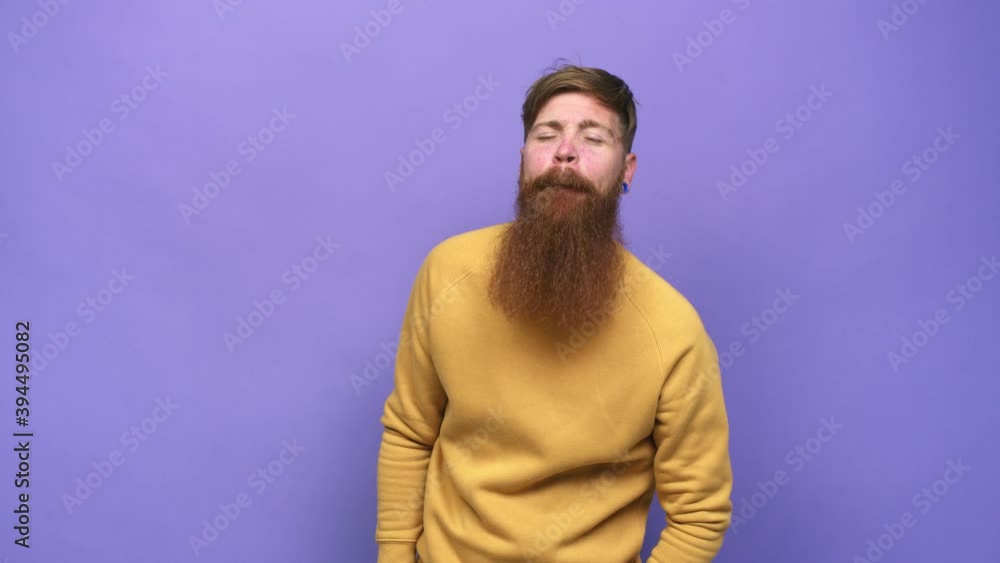 Young adult bearded caucasian man isolated funny and friendly sticking out tongue Young adult bearded caucasian man isolated funny and friendly sticking out tongue