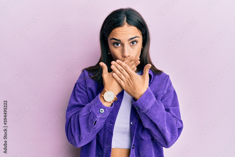 Young brunette woman wearing casual clothes shocked covering mouth with hands for mistake. secret concept. Young brunette woman wearing casual clothes shocked covering mouth with hands for mistake. secret concept.