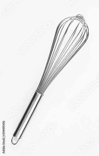 Silver eggbeater isolated on white background. Metallic kitchen tool