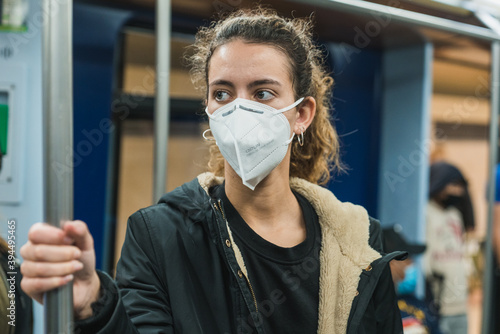 New normal. Young girl walking on the subway. Teenage girl walking on the subway. Mask against covid. Teenager with face mask. Pandemic. Young girl using the subway. Teenager riding the subway