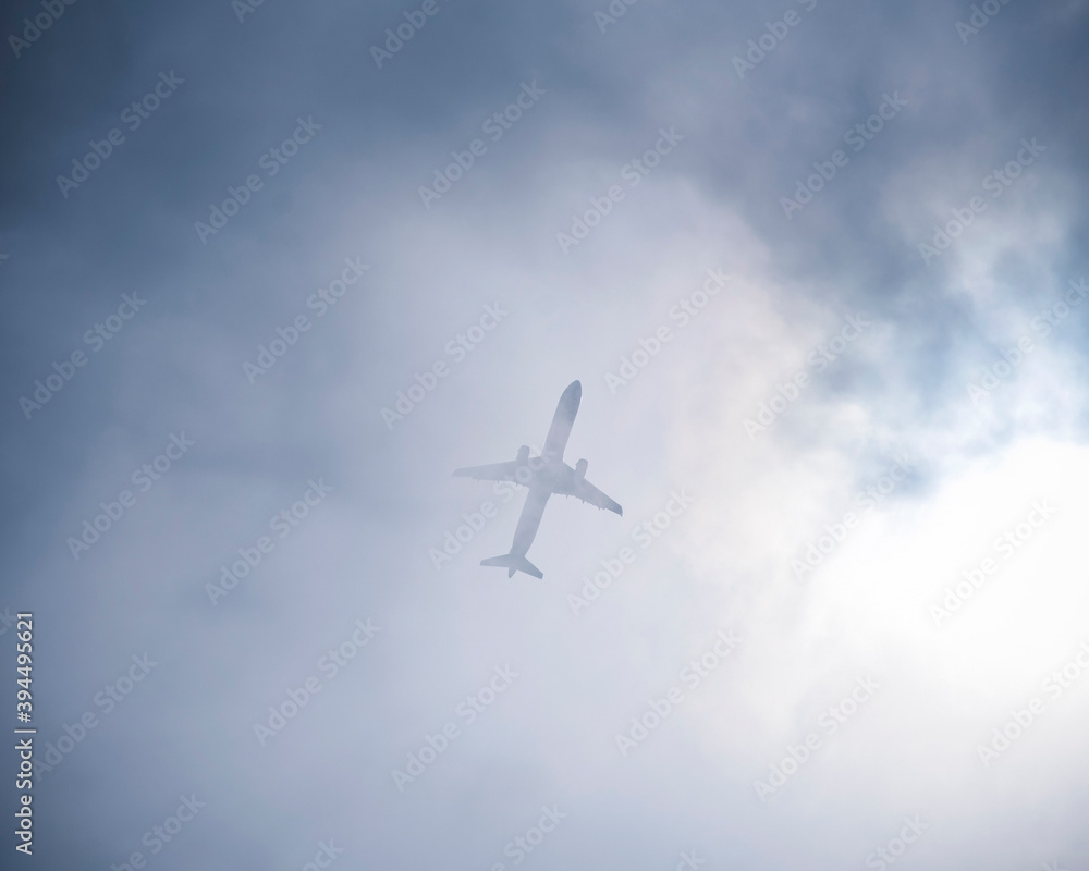 Airplane appearing through the clouds. Airplane appearing through the clouds.