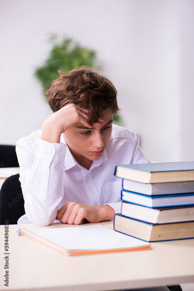 Schoolboy preparing for exams in the classroom Schoolboy preparing for exams in the classroom