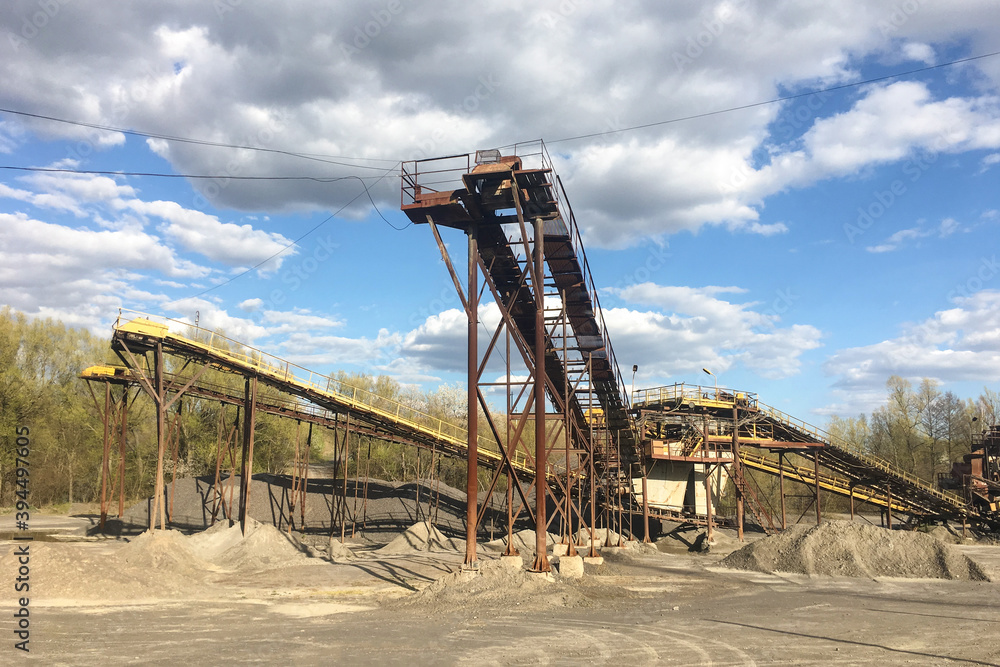Conveyor belts with piles of gravel in a granite quarry Conveyor belts with piles of gravel in a granite quarry