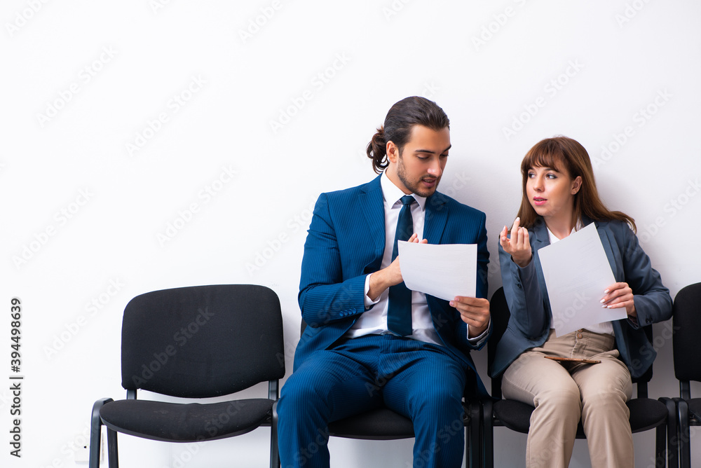 Obraz premium Young businessman and businesswoman waiting for an interview at