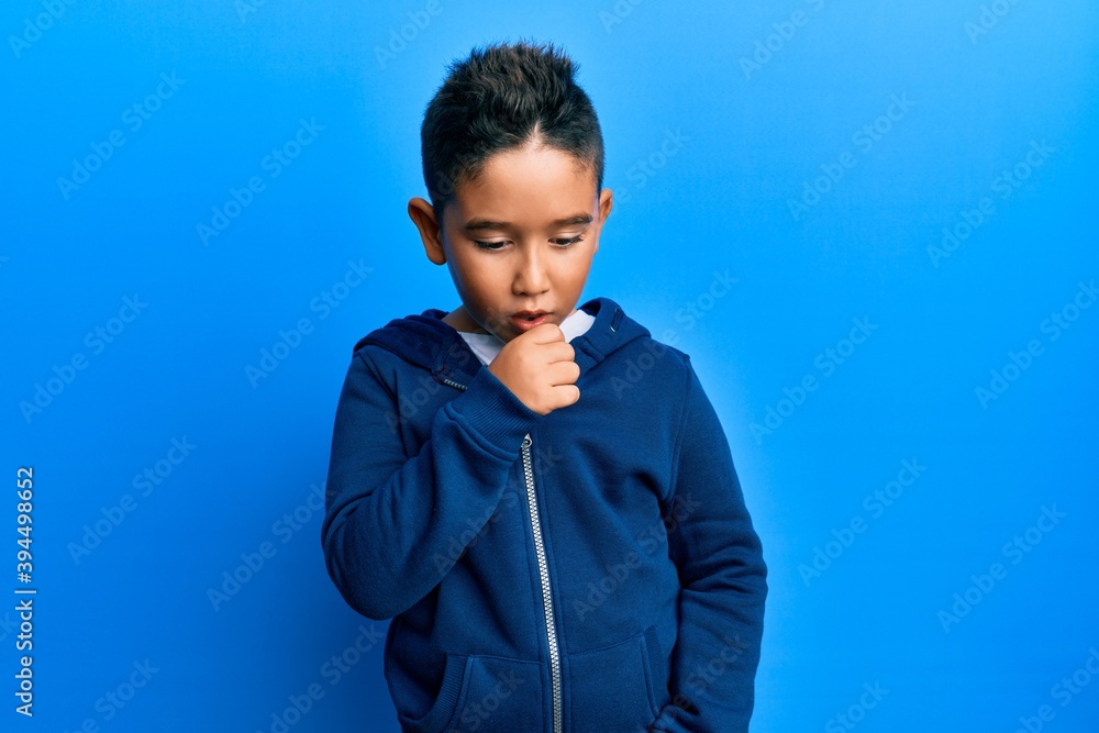 Little boy hispanic kid wearing casual sporty jacket feeling unwell and coughing as symptom for cold or bronchitis. health care concept. Little boy hispanic kid wearing casual sporty jacket feeling unwell and coughing as symptom for cold or bronchitis. health care concept.