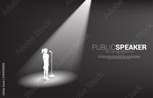Silhouette of businesswoman standing with microphone. Concept of front man and public speaking.
