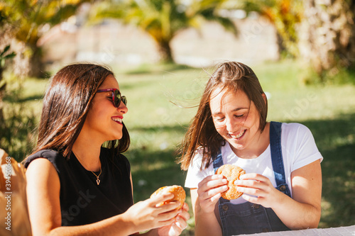 friends eating hamburger in the field