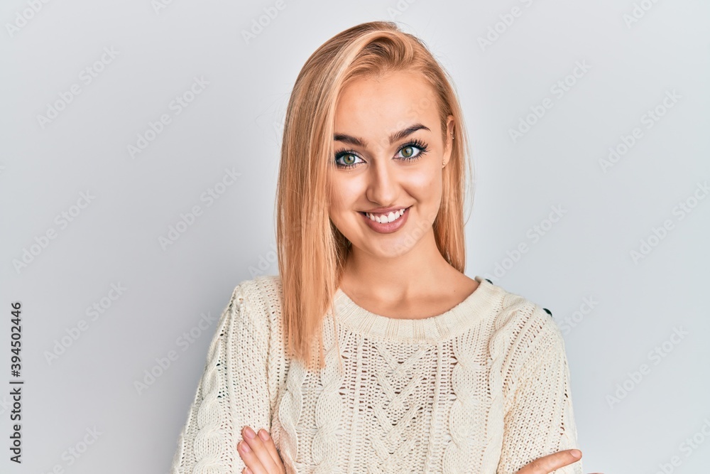 Beautiful caucasian woman wearing casual winter sweater happy face smiling with crossed arms looking at the camera. positive person. Beautiful caucasian woman wearing casual winter sweater happy face smiling with crossed arms looking at the camera. positive person.