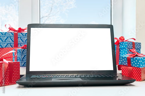 Computer display on table with isolated white screen. Christmas mock up.