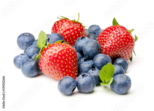 heap of blueberries and strawberries fruits isolated on white background