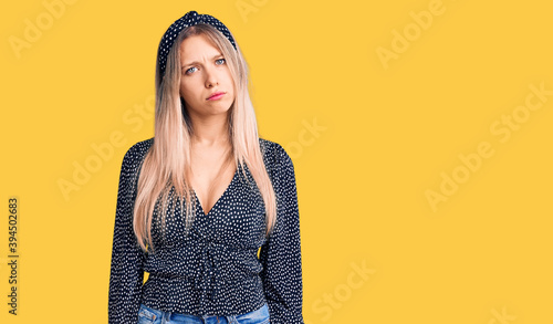 Obraz na plátně Young beautiful blonde woman wearing casual clothes skeptic and nervous, frowning upset because of problem