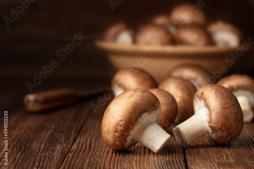 raw mushrooms in bowl on a wooden table