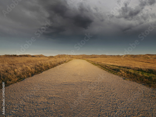 Empty gravel road leading t...