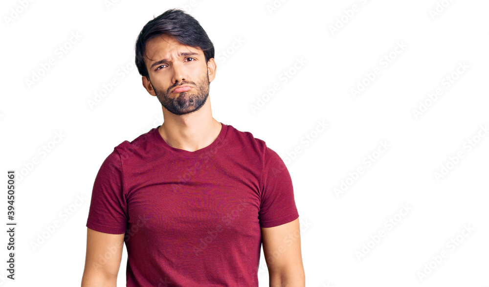 Fototapeta premium Handsome hispanic man wearing casual clothes depressed and worry for distress, crying angry and afraid. sad expression.