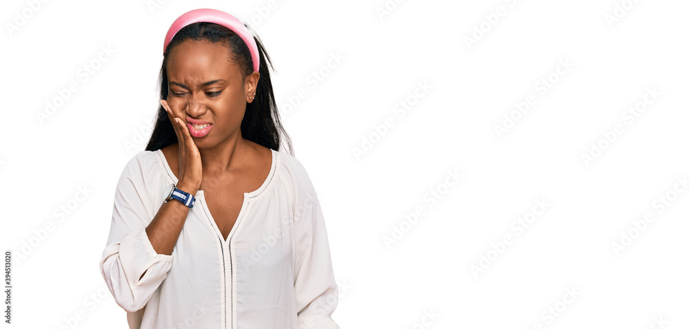 Young black woman wearing casual clothes touching mouth with hand with painful expression because of toothache or dental illness on teeth. dentist Young black woman wearing casual clothes touching mouth with hand with painful expression because of toothache or dental illness on teeth. dentist