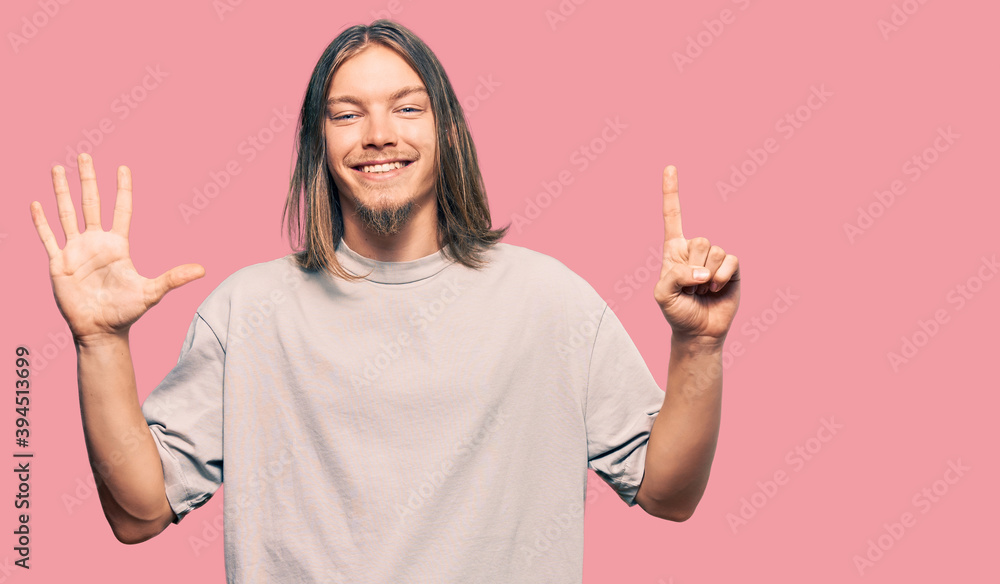 Handsome caucasian man with long hair wearing casual clothes showing and pointing up with fingers number six while smiling confident and happy. Handsome caucasian man with long hair wearing casual clothes showing and pointing up with fingers number six while smiling confident and happy.