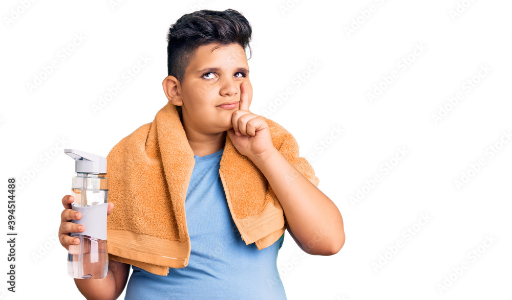 Little boy kid wearing sportswear drinking bottle of water serious face thinking about question with hand on chin, thoughtful about confusing idea Little boy kid wearing sportswear drinking bottle of water serious face thinking about question with hand on chin, thoughtful about confusing idea