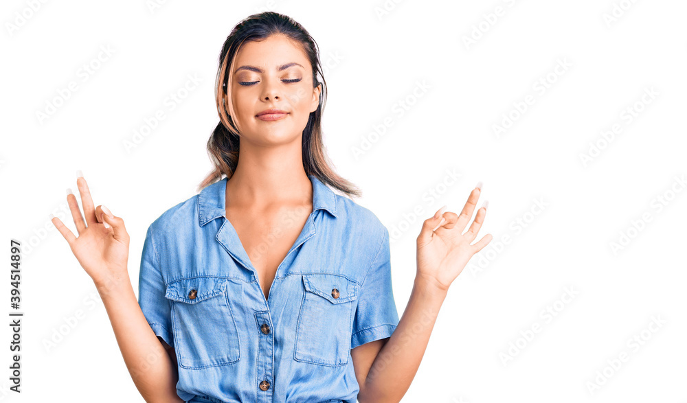Young beautiful woman wearing casual clothes relax and smiling with eyes closed doing meditation gesture with fingers. yoga concept. Young beautiful woman wearing casual clothes relax and smiling with eyes closed doing meditation gesture with fingers. yoga concept.