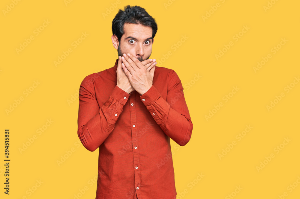 Young hispanic man wearing casual clothes shocked covering mouth with hands for mistake. secret concept. Young hispanic man wearing casual clothes shocked covering mouth with hands for mistake. secret concept.