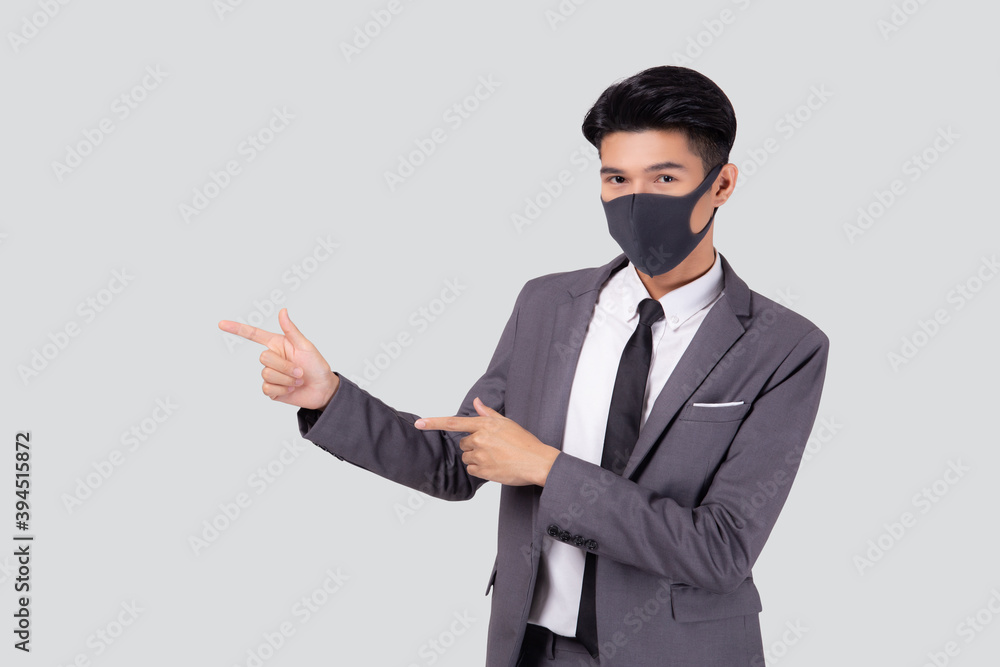 Portrait young asian businessman in suit wearing face mask for protective covid-19 isolated on white background, business man presenting and showing, quarantine for pandemic coronavirus, new normal. Portrait young asian businessman in suit wearing face mask for protective covid-19 isolated on white background, business man presenting and showing, quarantine for pandemic coronavirus, new normal.