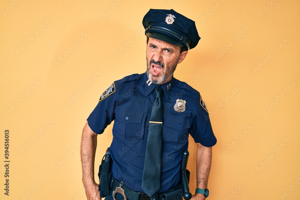 Middle age hispanic man wearing police uniform in shock face, looking skeptical and sarcastic, surprised with open mouth Middle age hispanic man wearing police uniform in shock face, looking skeptical and sarcastic, surprised with open mouth
