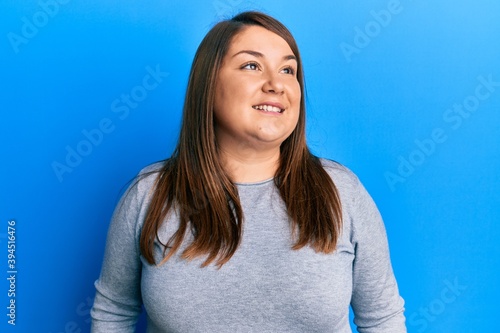 Beautiful hispanic plus size woman wearing casual clothes showing and pointing up with fingers number four while smiling confident and happy.