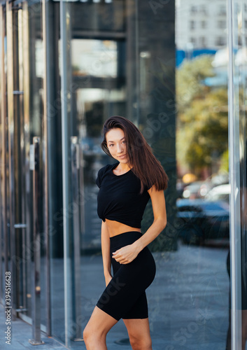 Beautiful woman, summer in city, fitness training on street. © teksomolika