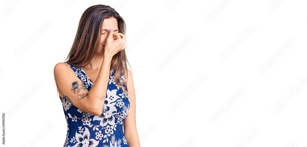 Beautiful caucasian woman wearing summer dress tired rubbing nose and eyes feeling fatigue and headache. stress and frustration concept. Beautiful caucasian woman wearing summer dress tired rubbing nose and eyes feeling fatigue and headache. stress and frustration concept.