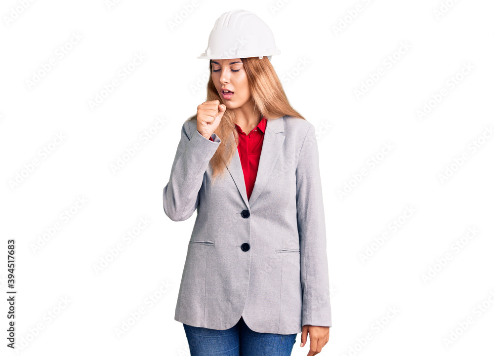 Beautiful young woman wearing architect hardhat feeling unwell and coughing as symptom for cold or bronchitis. health care concept. Beautiful young woman wearing architect hardhat feeling unwell and coughing as symptom for cold or bronchitis. health care concept.