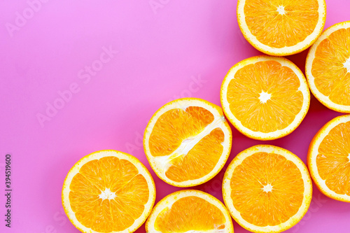 Sliced oranges on pink background. High vitamin C, Juicy and sweet.