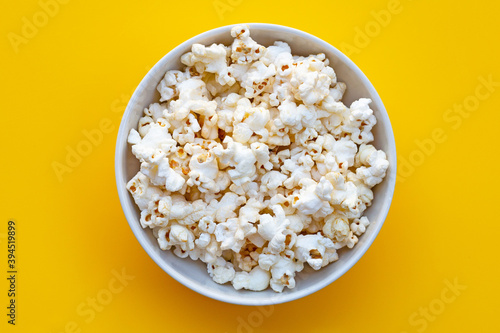 Popcorn on yellow background. Copy space