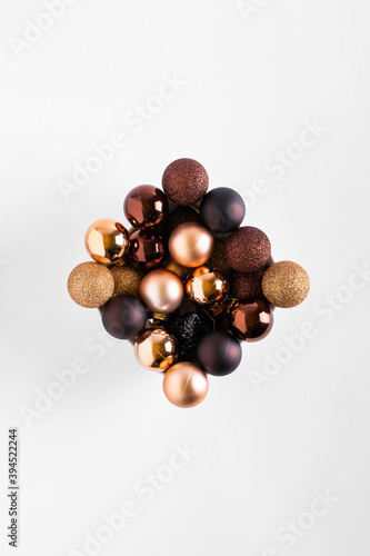 Minimal composition background of plastic brown decorative Christmas balls. New Year concept. Christmas balls on a white background
