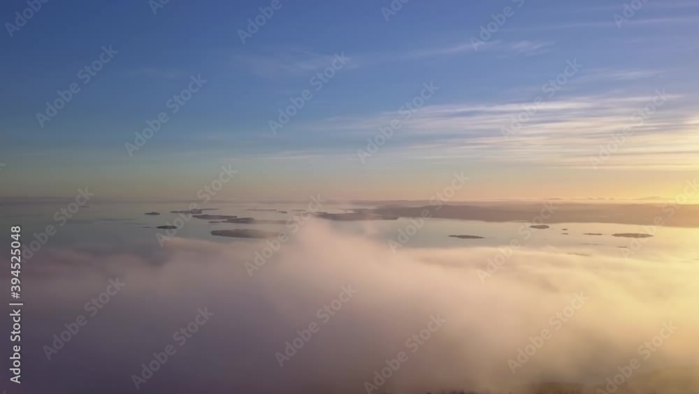 flying on a winter day in the sun above low clouds and the white sea in the distance flying on a winter day in the sun above low clouds and the white sea in the distance