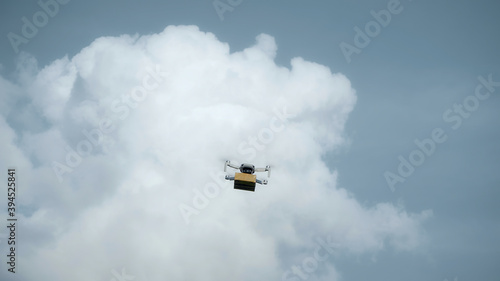 flying on a sky delivery drone with holding a .cardboard parcel