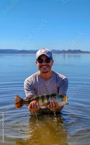 man displaying a fish in the river. sport fishing concept. fishing for fish in the river.