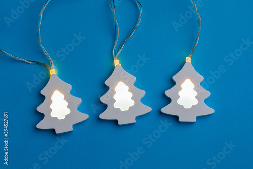 Christmas tree shape light garland, blue paper background