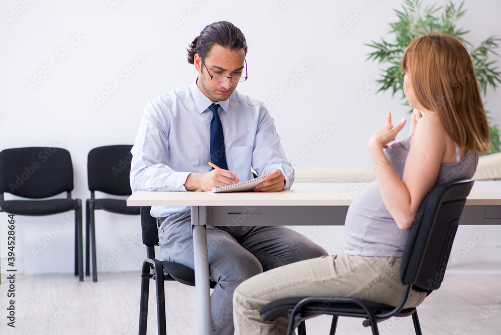 Pregnant woman visiting male psychologist doctor Pregnant woman visiting male psychologist doctor