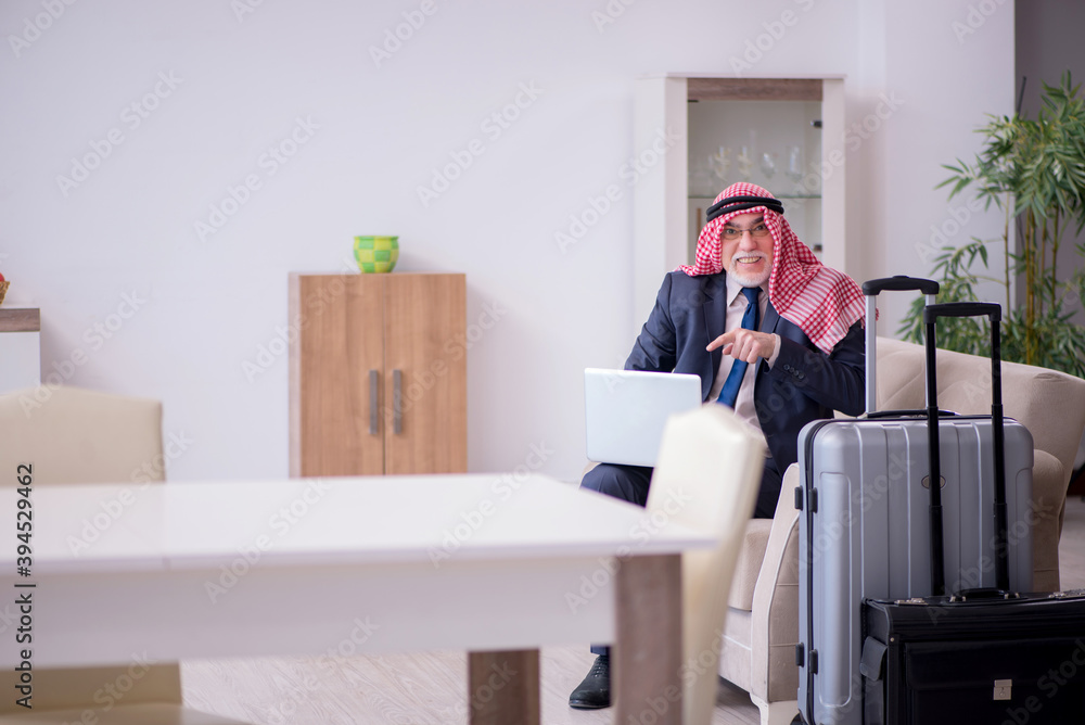 Old arab businessman preparing for business trip Old arab businessman preparing for business trip