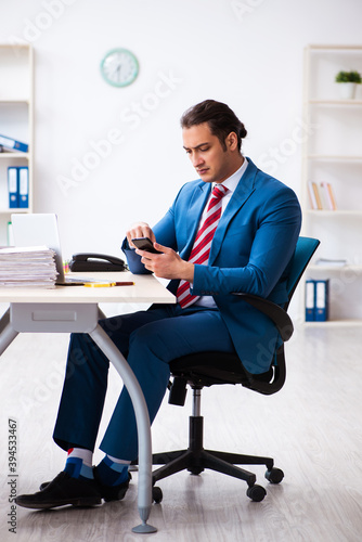 Young male employee working in the office