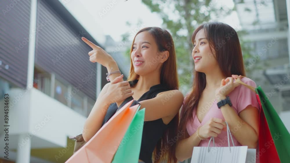 Two Asian young women enjoy shopping and walking in department store. Two Asian young women enjoy shopping and walking in department store.