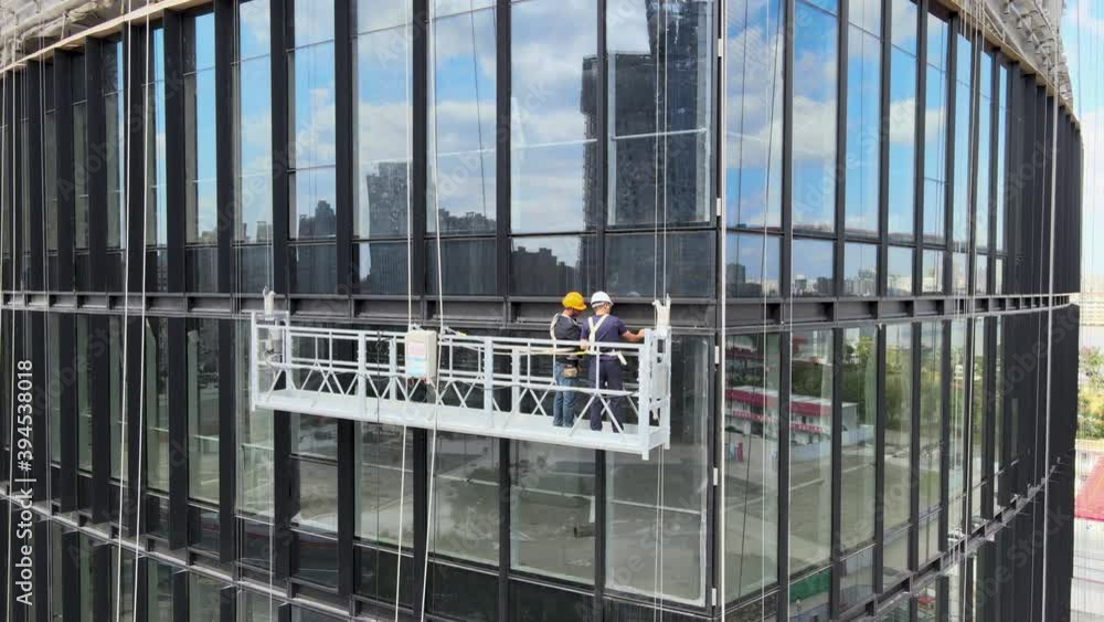 Office window installation worker in the construction site. House development. Business econpmy travel or industrial concept b-roll footage, drone aerial view in Shanghai China cityscape in background